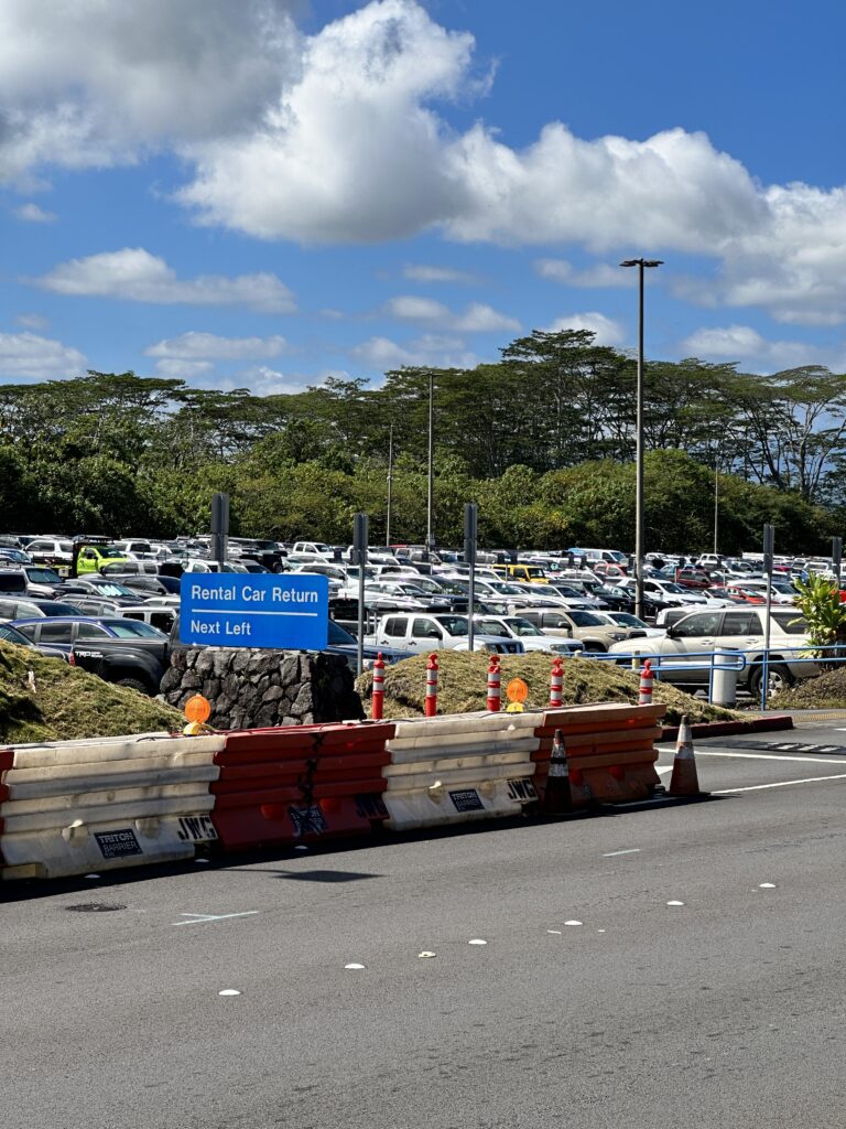Hilo International Airport Guide (2025) | Big Island Hawai'i (ITO) Hawaii Calling a parking lot with a sign and a road