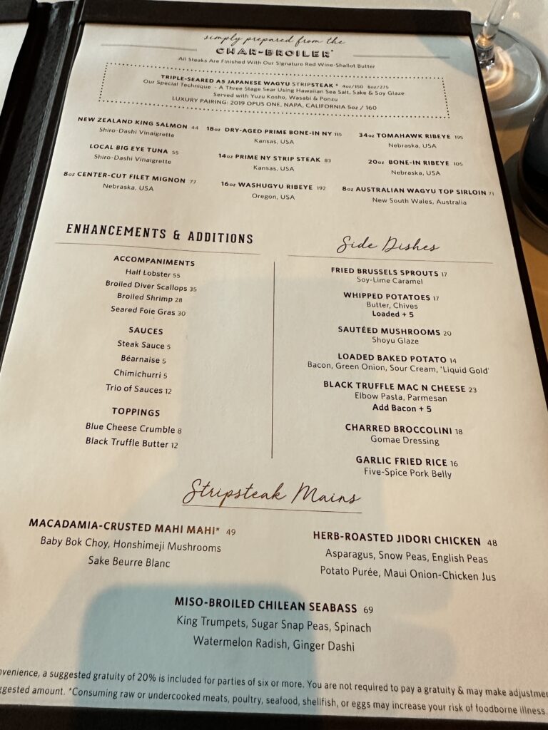 STRIPSTEAK Waikiki Review: A Sizzling Waikiki Steakhouse Experience Hawaii Calling a menu on a table
