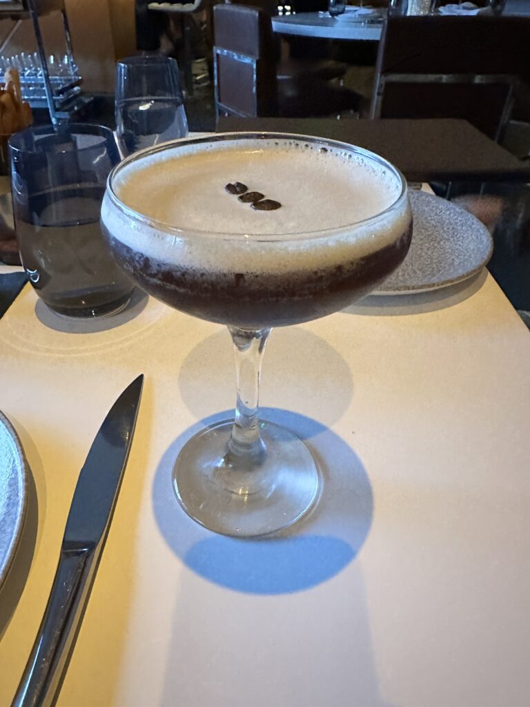 STRIPSTEAK Waikiki Review: A Sizzling Waikiki Steakhouse Experience Hawaii Calling a glass with brown liquid in it