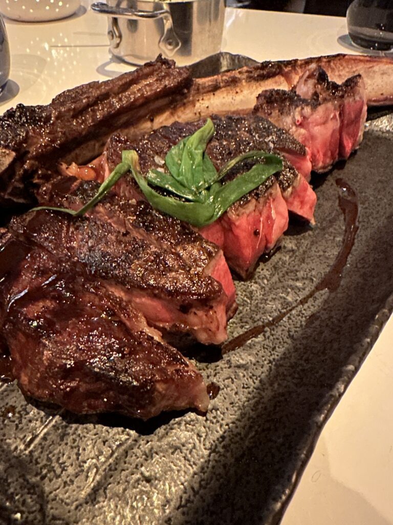 STRIPSTEAK Waikiki Review: A Sizzling Waikiki Steakhouse Experience Hawaii Calling a plate of steak with a leaf on it