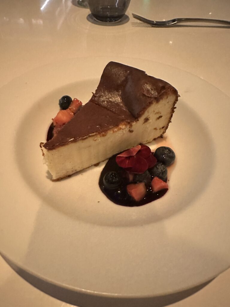 STRIPSTEAK Waikiki Review: A Sizzling Waikiki Steakhouse Experience Hawaii Calling a slice of cheesecake with fruit on a plate