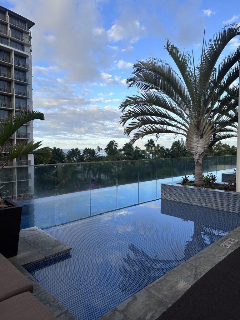 Ka La'i Waikiki Beach, A Hilton LXR Property | Review & Video Hawaii Calling a pool with a palm tree and a building in the background