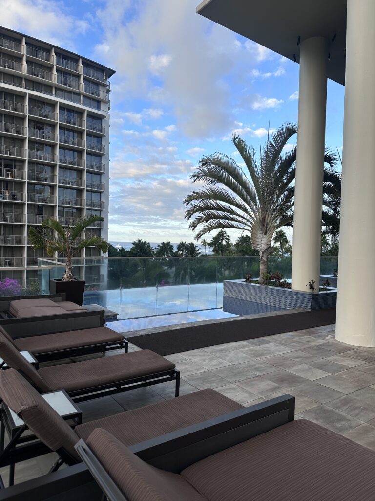 Ka La'i Waikiki Beach, A Hilton LXR Property | Review & Video Hawaii Calling a deck with chairs and palm trees