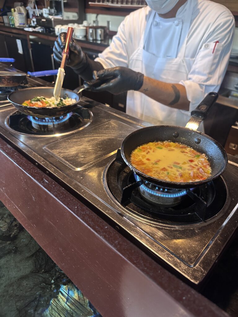 Ka La'i Waikiki Beach, A Hilton LXR Property | Review & Video Hawaii Calling a person cooking food on a stove