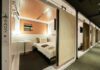 Is This the Future of Waikiki Hotels? First Cabin’s Luxury Capsule Concept Lands in Hawai’i a room with a bed and a table