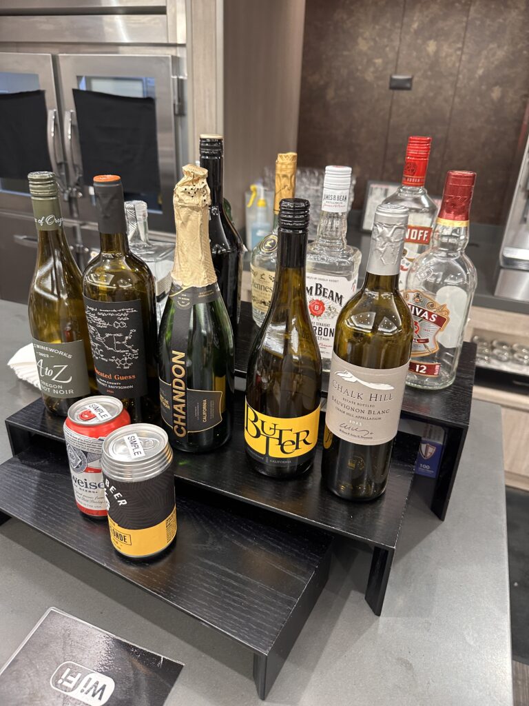 American Airlines Premium Economy Review: Honolulu (HNL) to Phoenix (PHX) on the Boeing 787-8 Hawaii Calling a group of bottles on a shelf