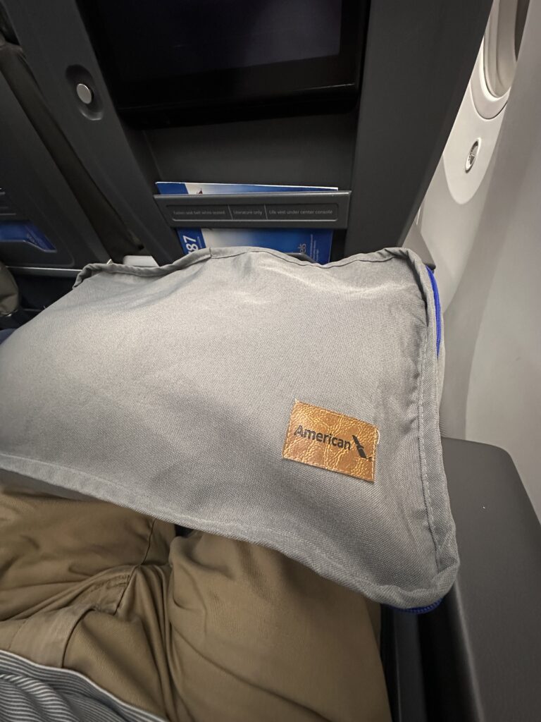 American Airlines Premium Economy Review: Honolulu (HNL) to Phoenix (PHX) on the Boeing 787-8 Hawaii Calling a pillow on a person's lap