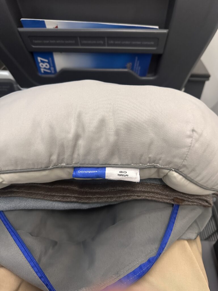 American Airlines Premium Economy Review: Honolulu (HNL) to Phoenix (PHX) on the Boeing 787-8 Hawaii Calling a pillow with a label on it