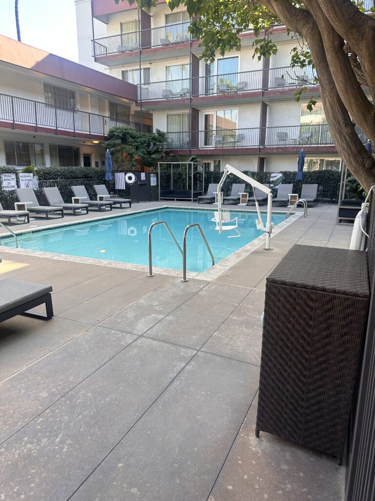 Fairfield Inn & Suites Los Angeles LAX/El Segundo | Hotel Review Hawaii Calling a pool with chairs and a tree in the background