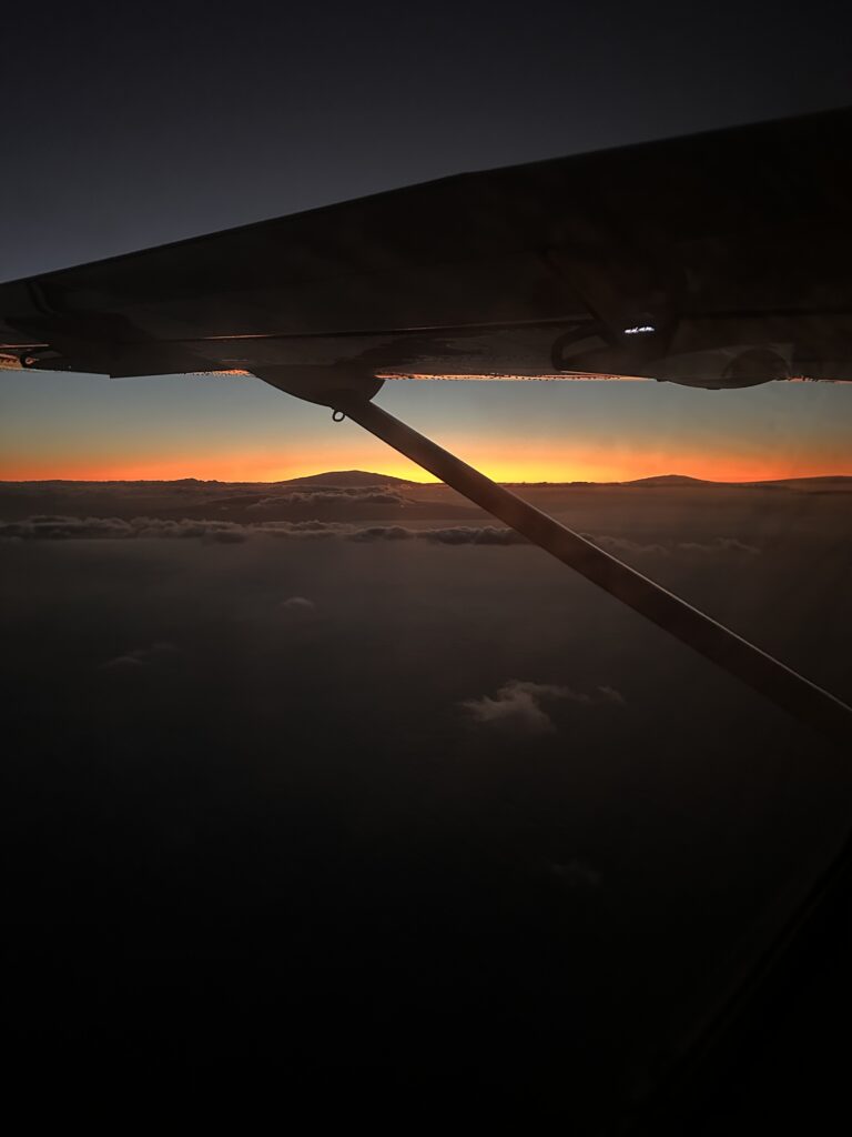 Mokulele Airlines Review: Honolulu (HNL) to Lāna‘i (LNY) | A Scenic Solo Flight Review Hawaii Calling an airplane wing with the sun setting behind it