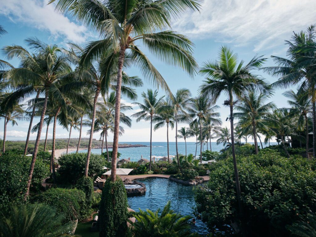 Hawai‘i Hotel Named #1 in the USA for 2025—2 More in the Top 10 Hawaii Calling a pool surrounded by palm trees and a beach