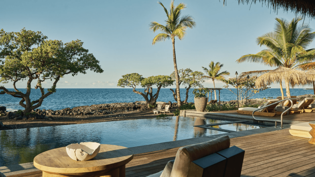 Hawai‘i Hotel Named #1 in the USA for 2025—2 More in the Top 10 Hawaii Calling a pool with a deck and chairs on a beach
