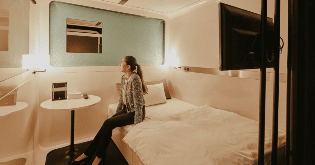 Is This the Future of Waikiki Hotels? First Cabin’s Luxury Capsule Concept Lands in Hawai'i Hawaii Calling a woman sitting on a bed