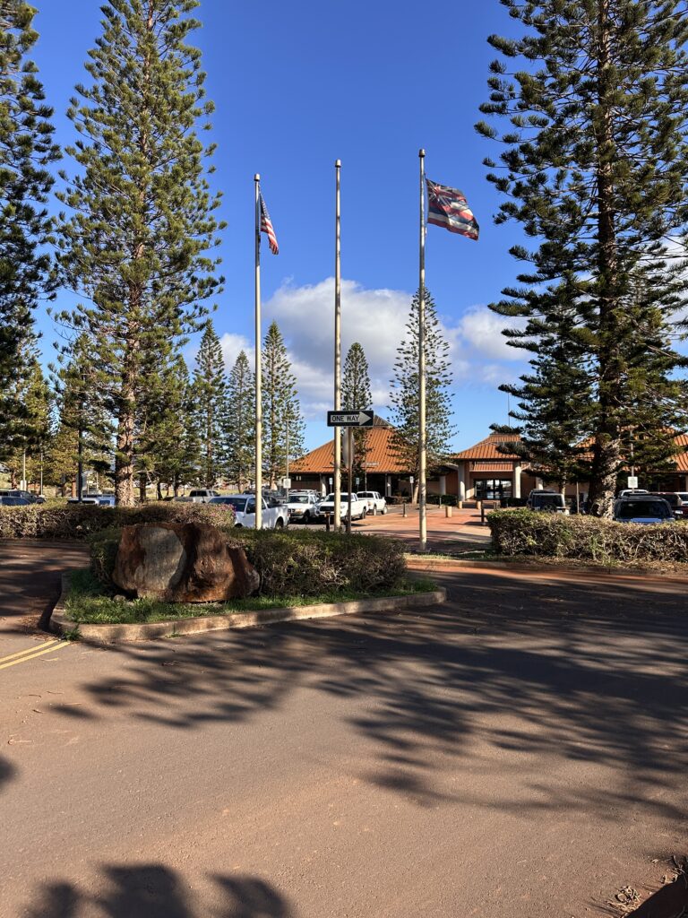 Lanai Airport Guide | (LNY) Lānaʻi Island Hawai'i Hawaii Calling flags on poles in front of a building