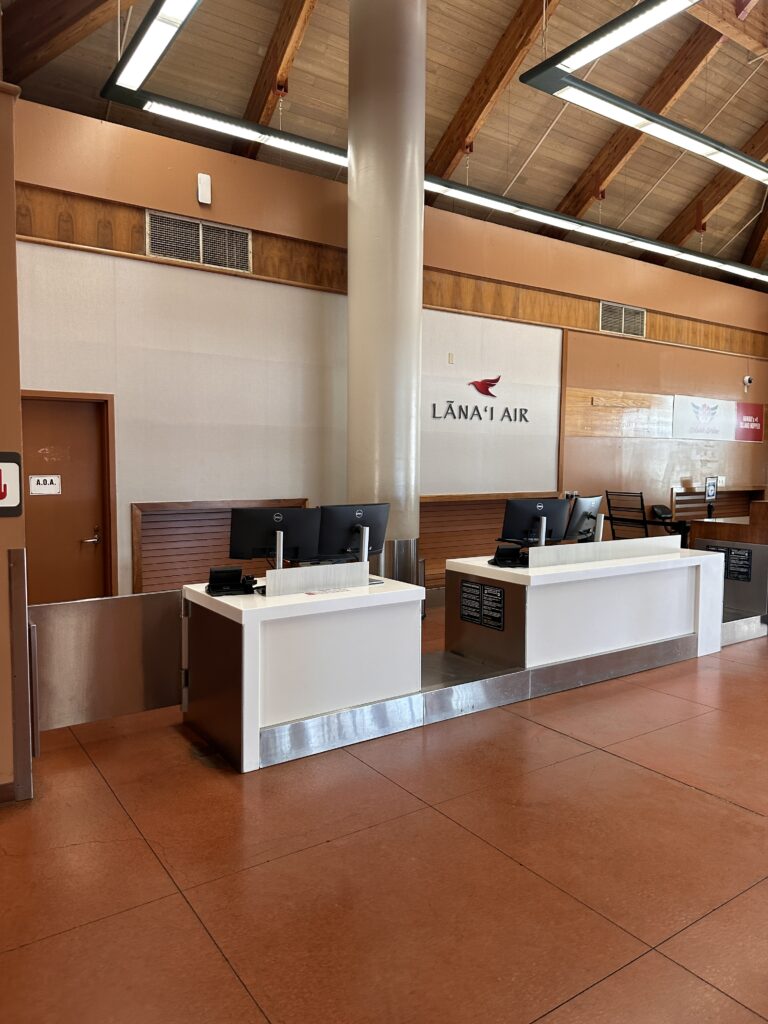 Lanai Airport Guide | (LNY) Lānaʻi Island Hawai'i Hawaii Calling a reception area with computers and a large white column