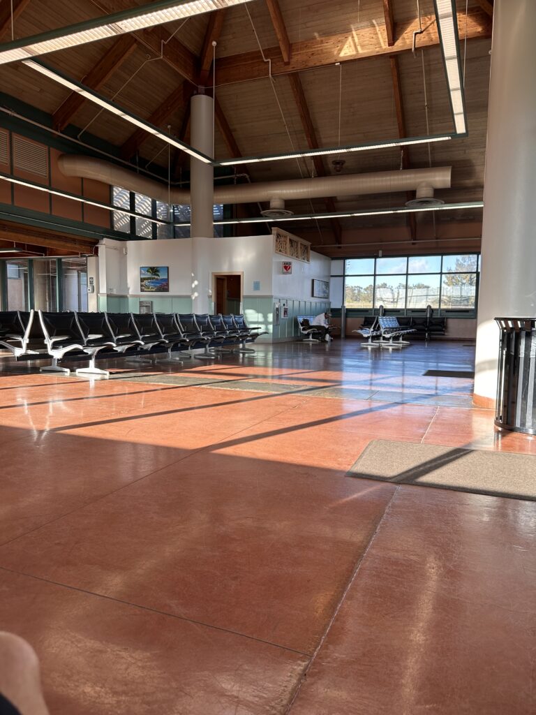 Lanai Airport Guide | (LNY) Lānaʻi Island Hawai'i Hawaii Calling a large room with chairs and a large window Lānaʻi Airport Terminal