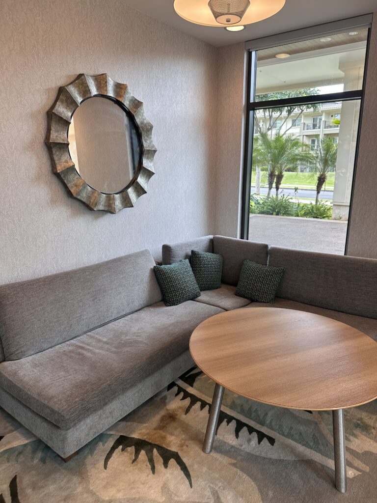 Residence Inn Oahu Kapolei: A Smart Option for Longer Stays on Oʻahu Hawaii Calling a couch with a round table and a mirror on the wall