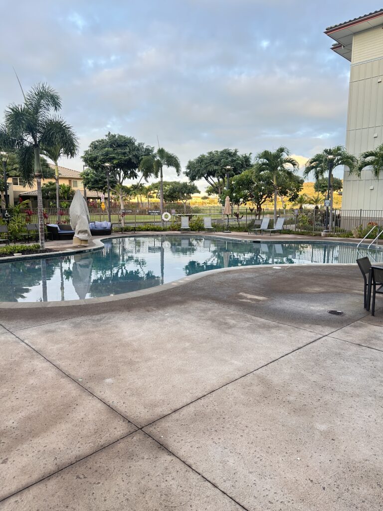 Residence Inn Oahu Kapolei: A Smart Option for Longer Stays on Oʻahu Hawaii Calling a pool with chairs and trees around it