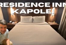 Residence Inn Oahu Kapolei: A Smart Option for Longer Stays on Oʻahu a bed with white sheets and a lamp on the side