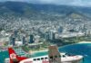 JAL Travelers Can Now Book Seamless Flights to Hawai‘i’s Most Remote Airports a plane flying over a city