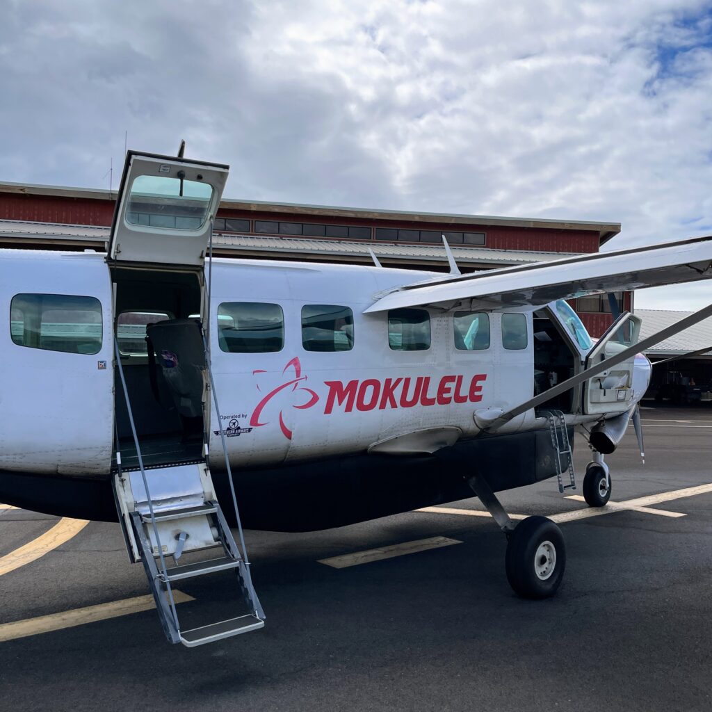 Mokulele Airlines Anniversary BOGO Sale — Island Hopping Made Better Hawaii Calling a plane parked on the ground