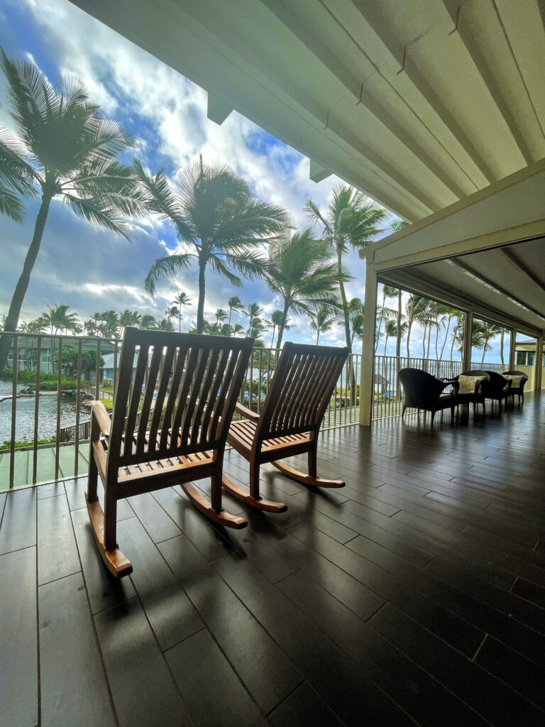 What Hotel Was The New Lilo & Stitch Movie Filmed? Inside the Iconic Kahala Hotel On Oahu Hawaii Calling a deck with chairs and trees in the background