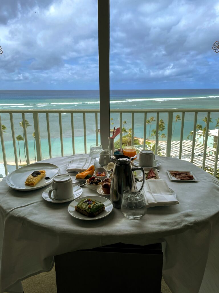 What Hotel Was The New Lilo & Stitch Movie Filmed? Inside the Iconic Kahala Hotel On Oahu Hawaii Calling a table with food on it and a view of the ocean