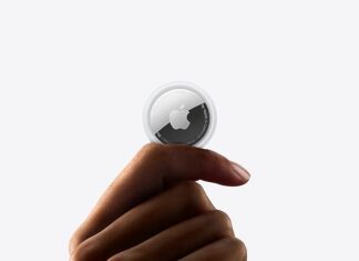 a hand holding a small round object