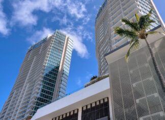 a tall buildings with a palm tree