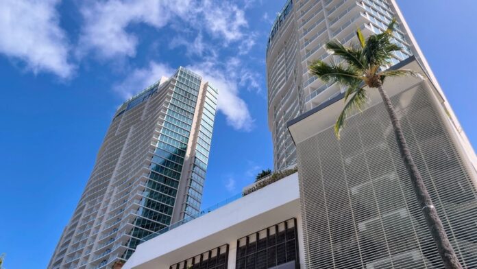 a tall buildings with a palm tree