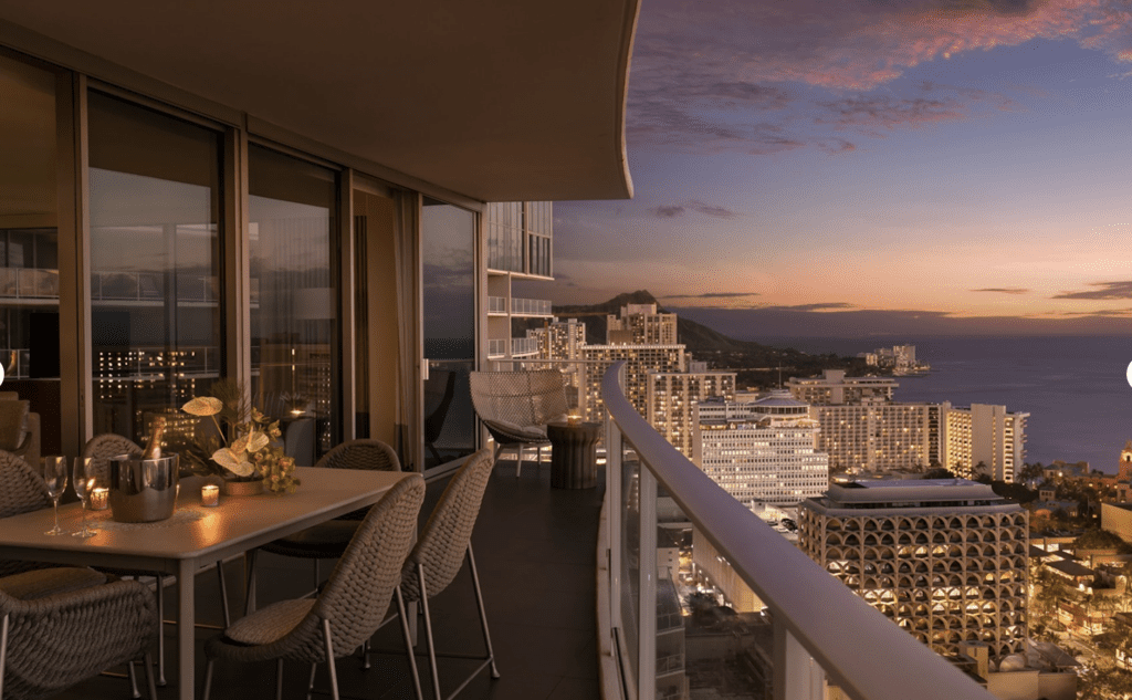 a balcony with a table and chairs and a city view