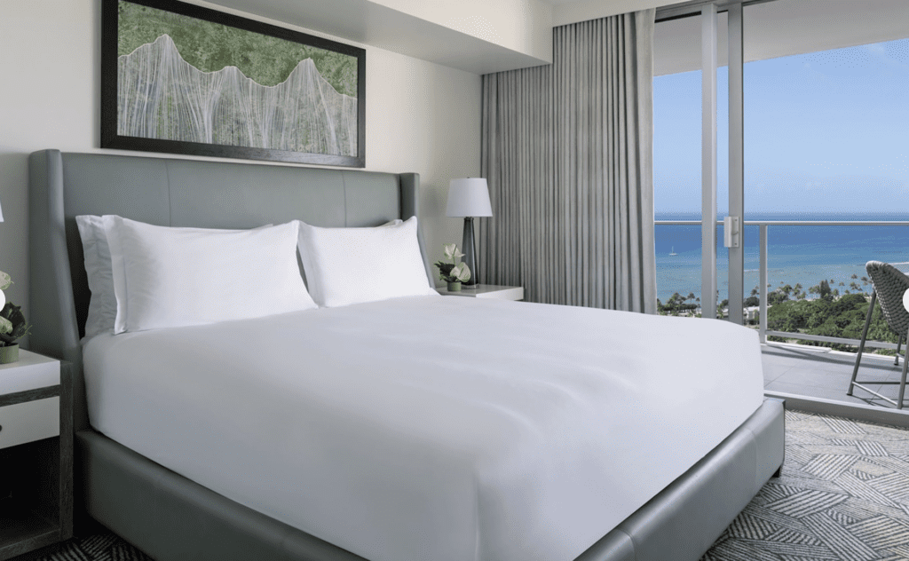 a bed with a view of the ocean