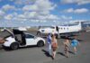 Free Flights from Honolulu to Lānaʻi with Four Seasons Resort Bookings Through 2026 a group of people walking towards an airplane