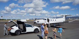 Free Flights from Honolulu to Lānaʻi with Four Seasons Resort Bookings Through 2026 a group of people walking towards an airplane