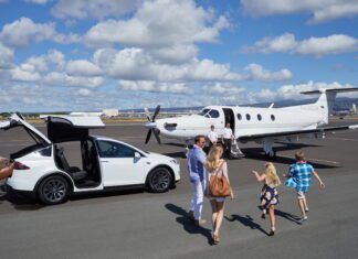 Free Flights from Honolulu to Lānaʻi with Four Seasons Resort Bookings Through 2026 a group of people walking towards an airplane