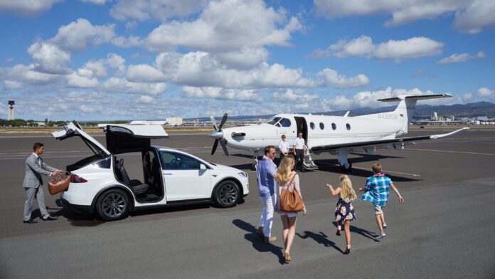a group of people walking towards an airplane