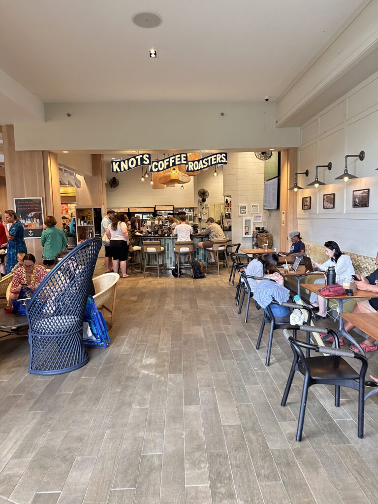 people sitting at tables in a restaurant