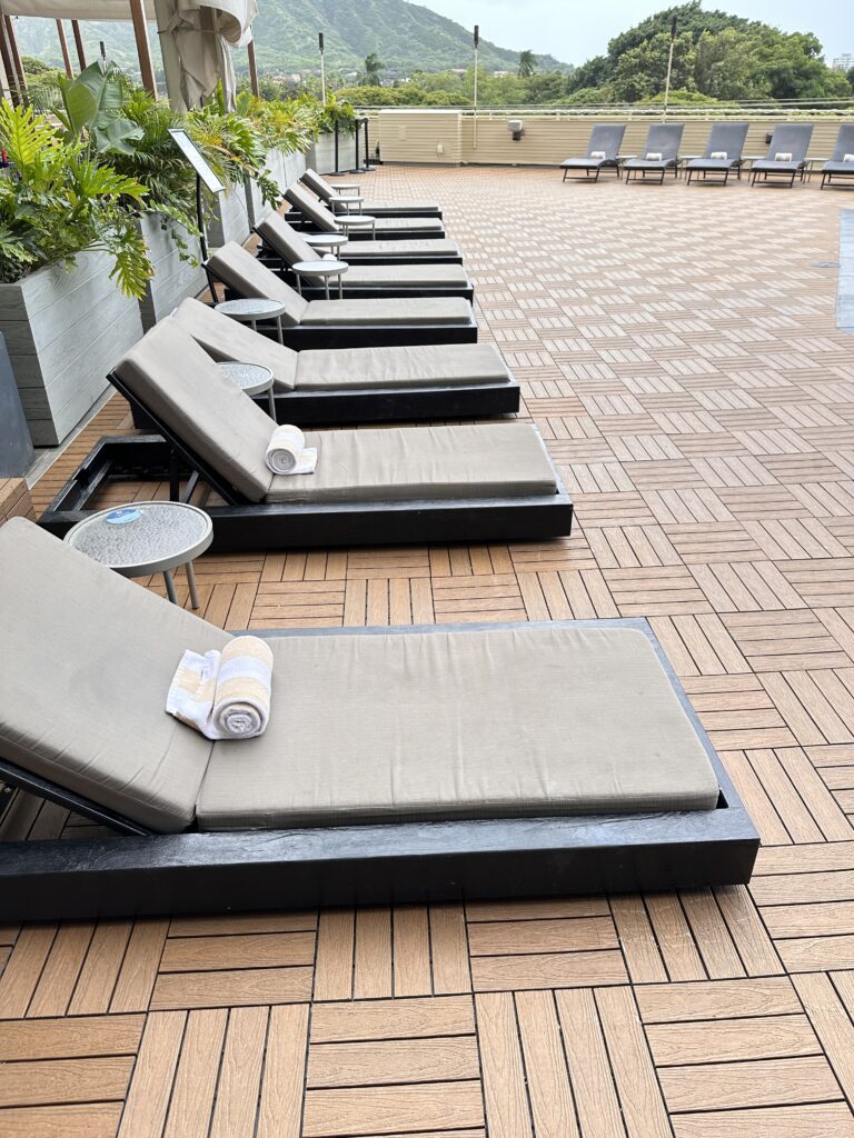 a group of lounge chairs on a brick patio
