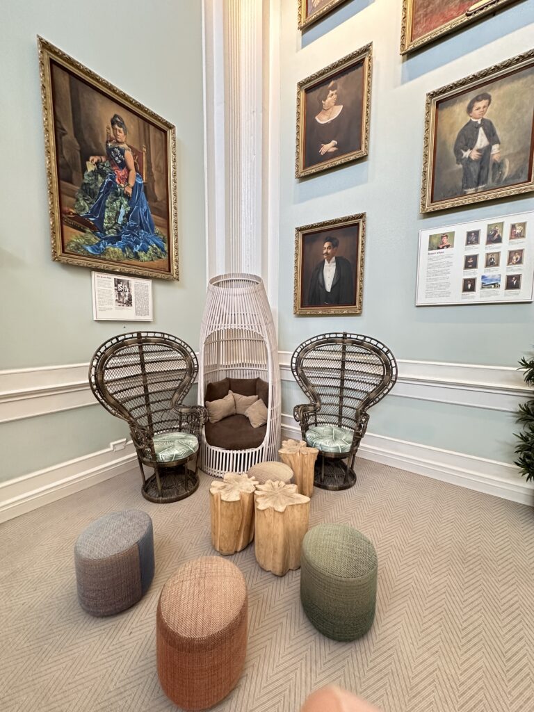 a room with wicker chairs and stools