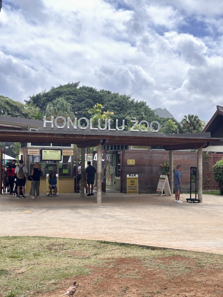 a group of people outside a zoo