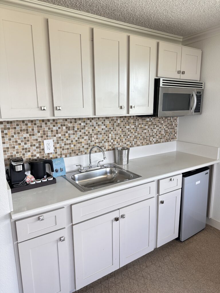 a kitchen with white cabinets and a sink