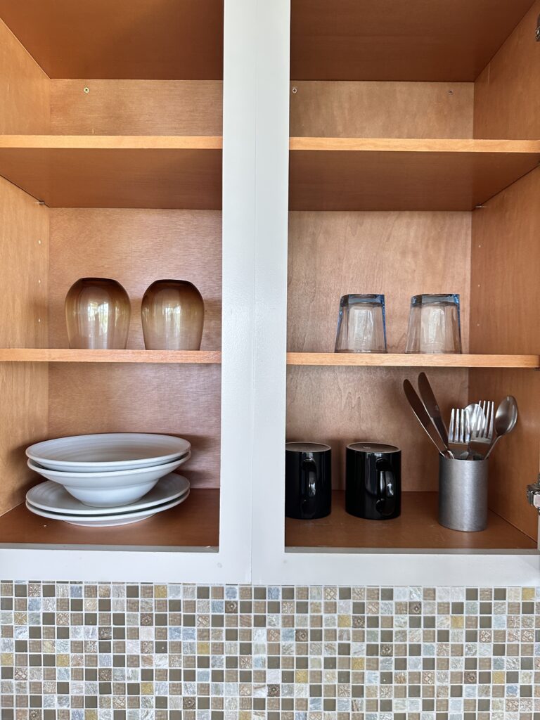 a cupboard with plates and glasses