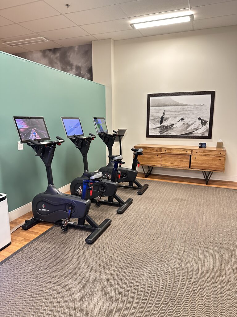 a room with exercise bikes and computers