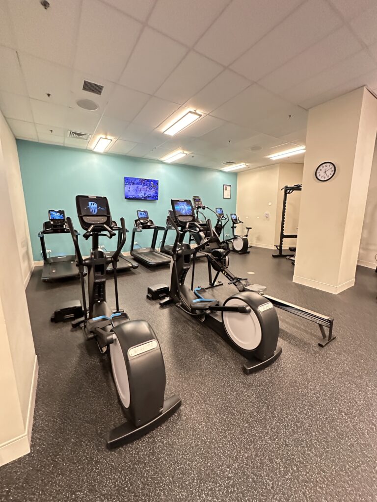 a room with exercise bikes and a clock