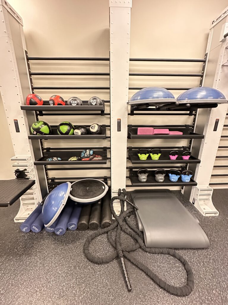 a gym with exercise equipment and balls