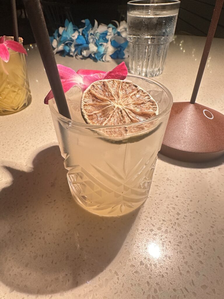 a glass with a slice of lemon and a straw