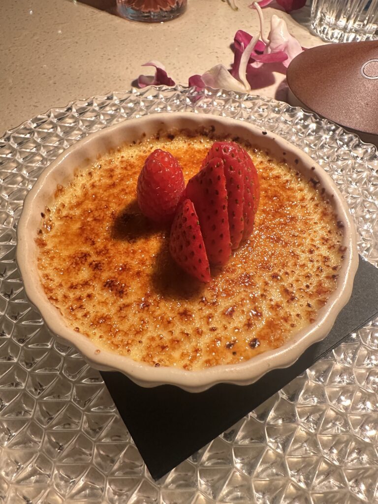 a bowl of creme brulee with strawberries