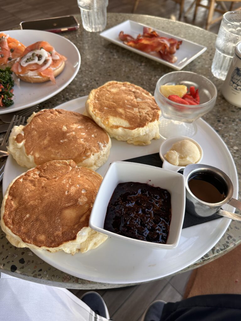 a plate of pancakes with jam and sauce