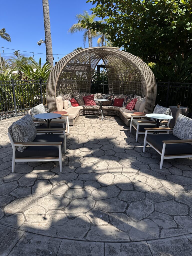 a patio area with chairs and a table