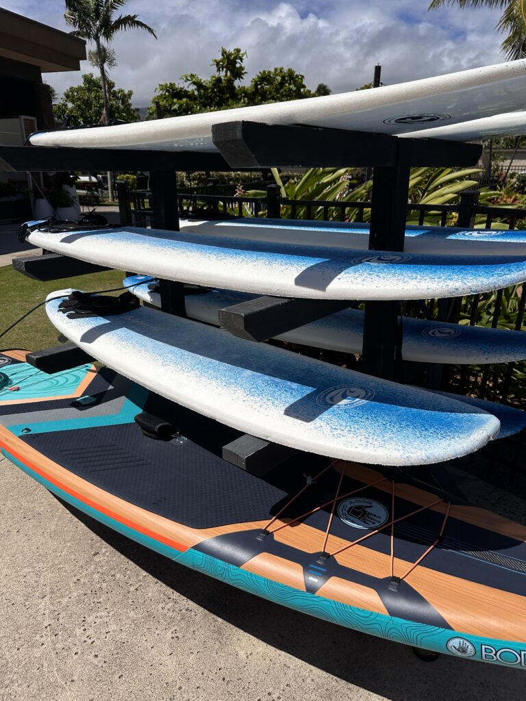 a rack of surfboards on a sidewalk